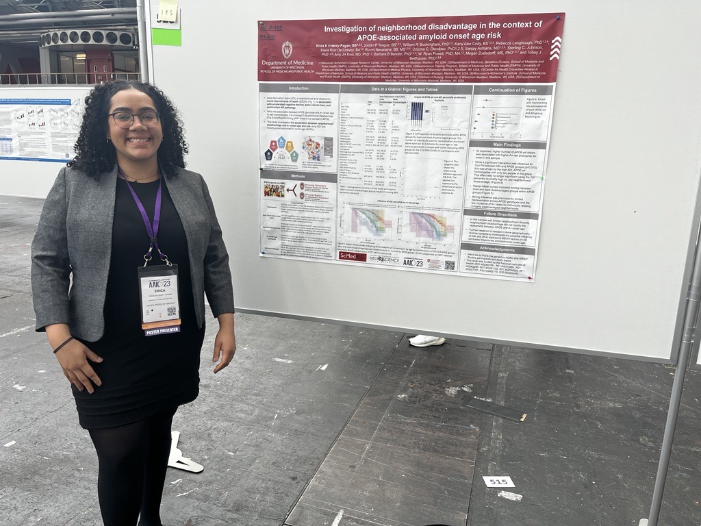 Erica Irizarry Pagan standing in front of her research poster at AAIC 2023.