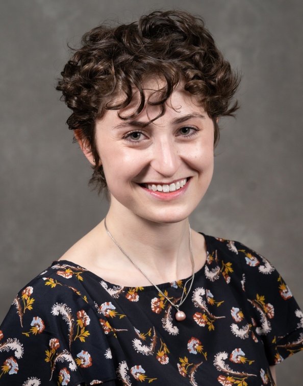 Headshot of Margo Heston on grey backdrop.