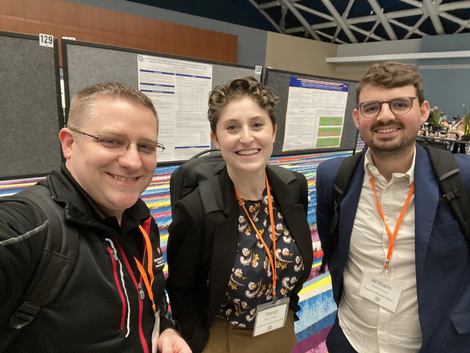 Left to Right: Tobey Betthauser, Margo Heston, Will Coath. Smiling in front of posters. 