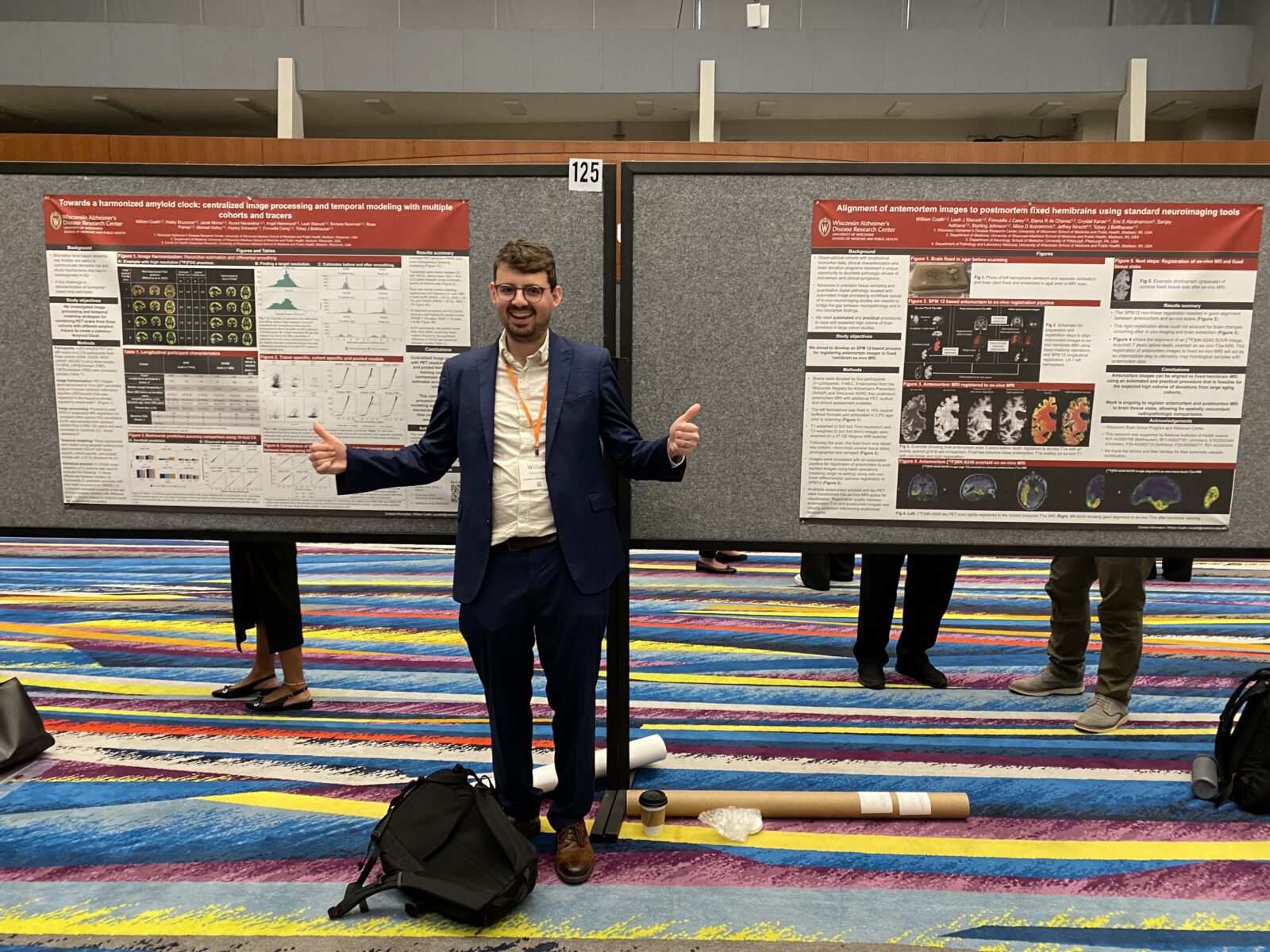 Will Coath giving two thumbs up in front of the two research posters he presented. 